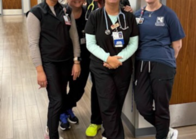 Young Women in black scrubs stand posed together