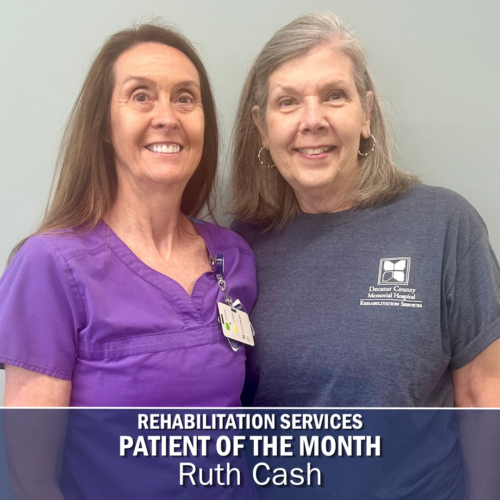 Two women stand side by side posed for a photo. the woman on the left has on a purple top, and the woman on the left has on a navy tshirt that says "Decatur County Memorial Hospital Rehabilitation Services"