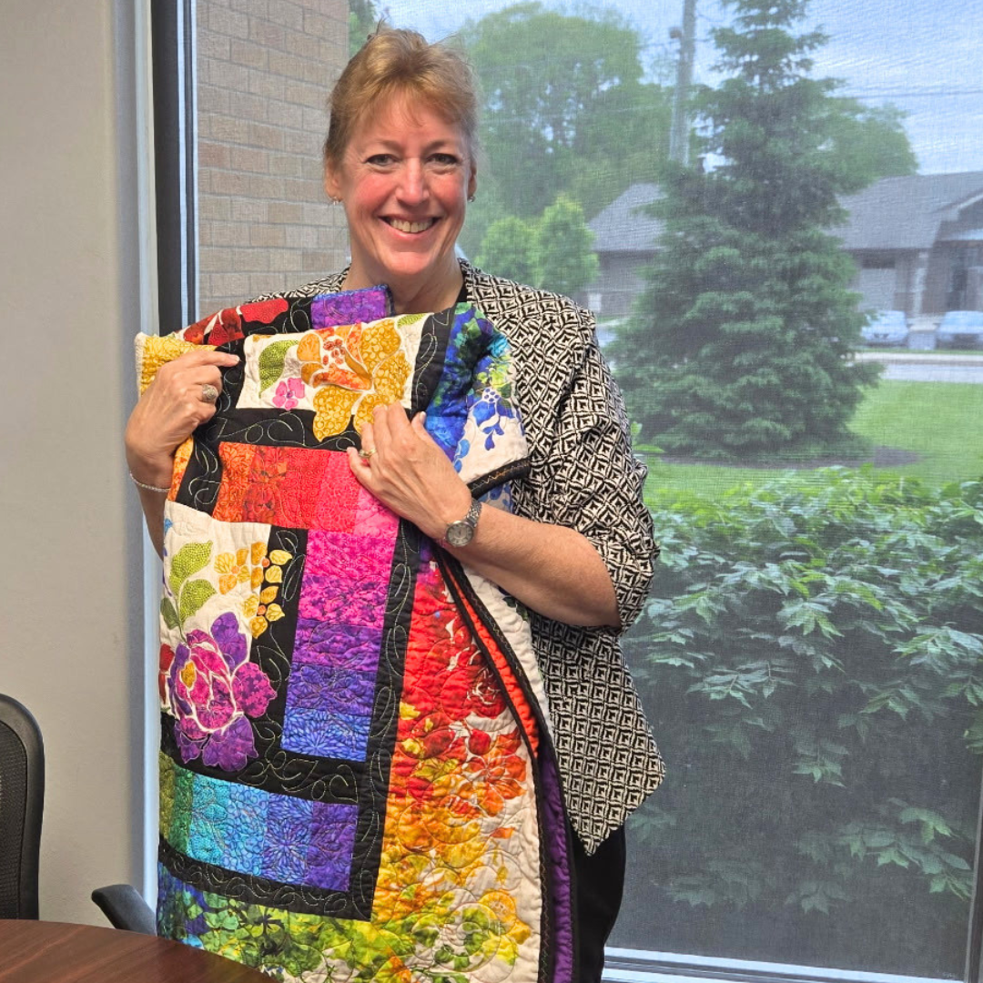 DCMH CFO Catherine Keck with Handmade Quilt