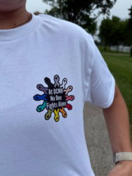 Walk with Care t-shirts with cancer awareness ribbons and 'At DCMH No One Fights Alone'
